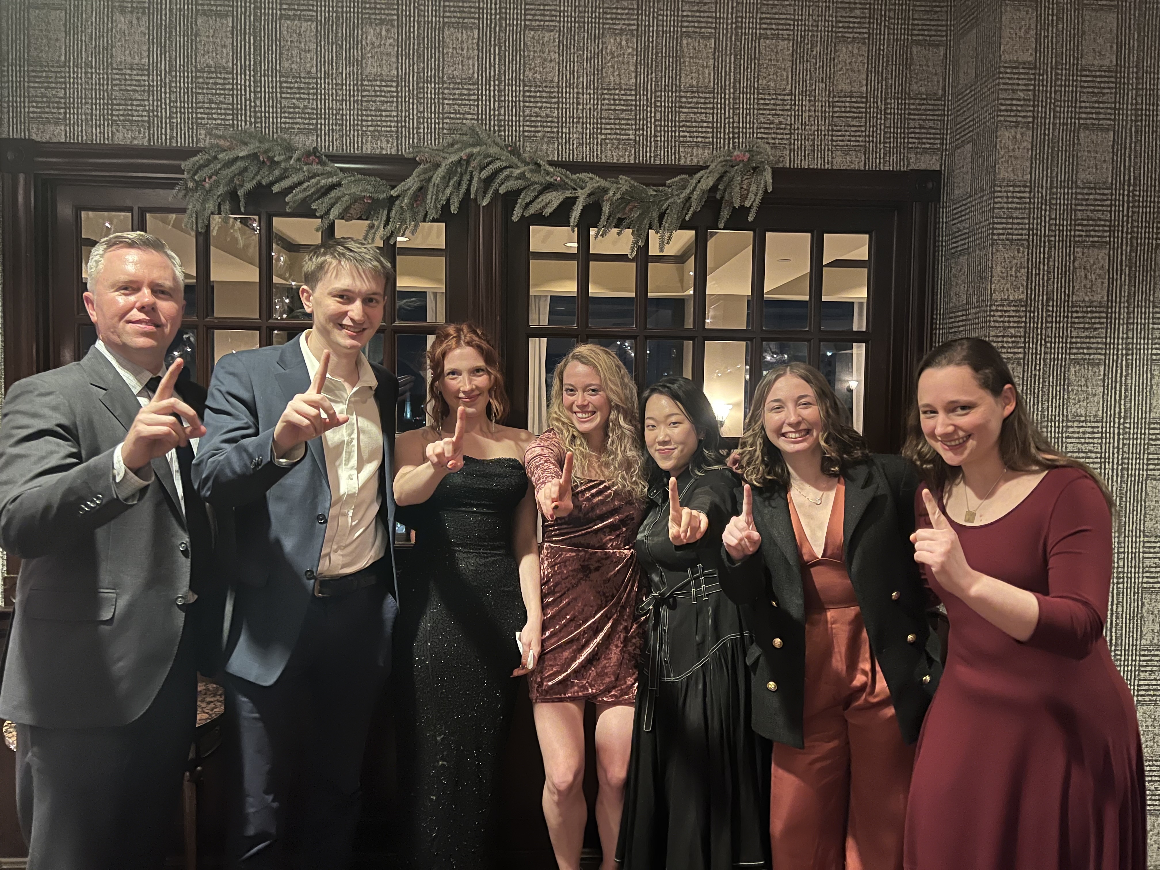 Lab members hold up one finger (for first place) and smile