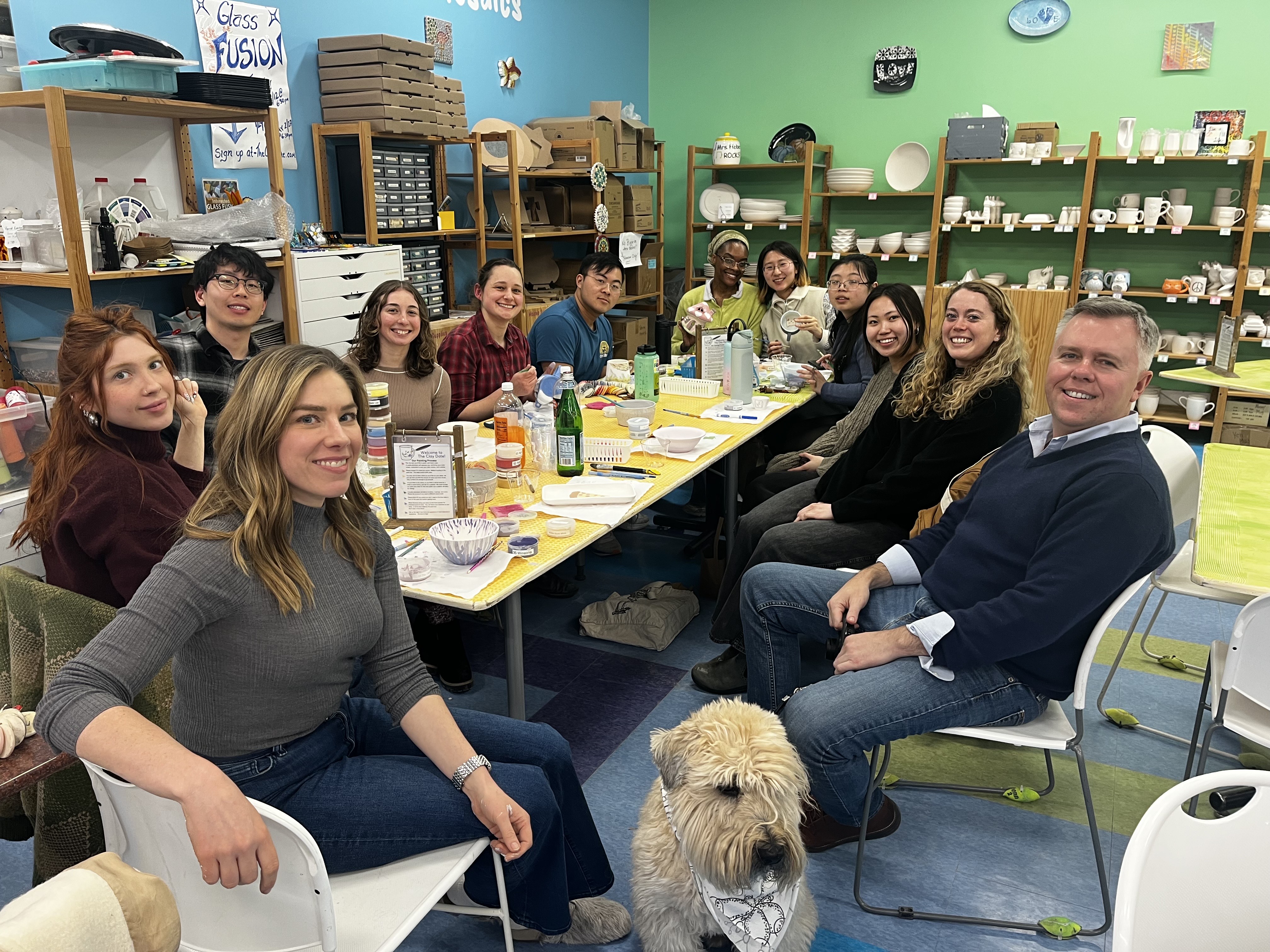 Photo of lab members painting pottery